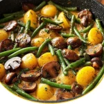 Leckere Kartoffel-Pilz-Pfanne mit Bohnen auf einem Teller angerichtet