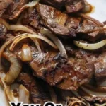 Hübsch angerichtete Kalbsleber mit Zwiebeln auf einem weißen Teller