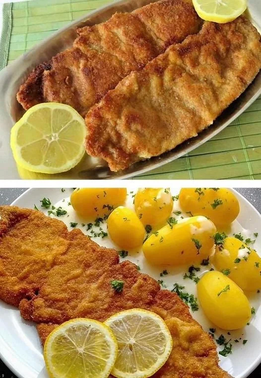 Wiener Schnitzel serviert mit Zitrone und Petersilie auf einem Teller.