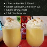 Eine Tasse Eierpunsch mit Zimtstange und Gewürzen auf einem Tisch